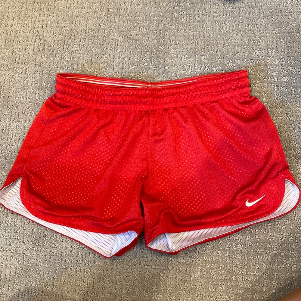 Worn Womens Nike Dri-Fit Polyester Mesh Shorts. Red with white Nike Swoosh. XS
